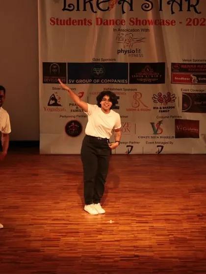 The dancers strike a classic, presentational pose at the end of their performance.