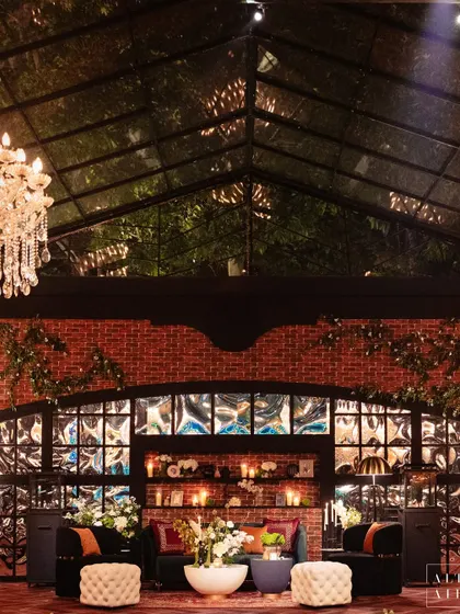 The glass house structure itself, with its transparent roof, allowed us to bring the outdoors in. We used exposed brick and creeping vines to enhance the industrial yet romantic feel.
