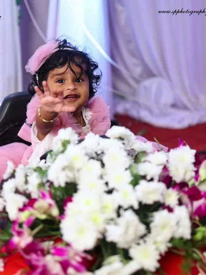 This photo captures the pure joy of a baby's grand entrance at her party. We focus on capturing these unscripted, personality-filled moments that you will cherish forever.