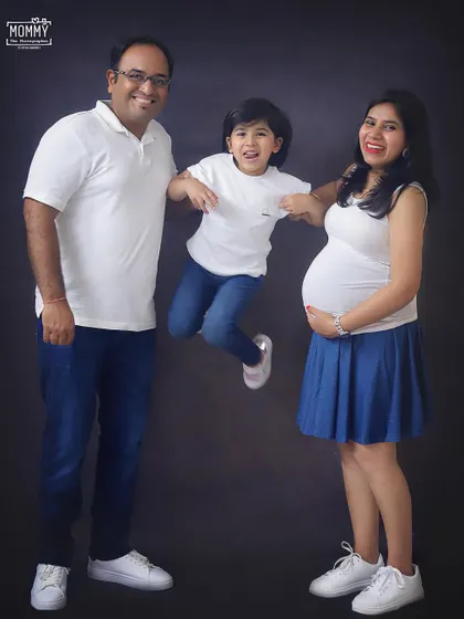 So much happiness in one photo! I love capturing the energy and excitement of the older sibling, jumping for joy about the new baby on the way.