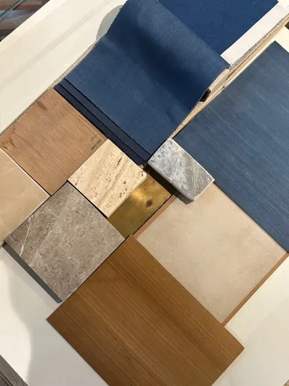 One of the curated mood boards for the commercial project. This palette combines rich blues, warm woods, and different types of marble to distinguish between public and private zones in the office space.