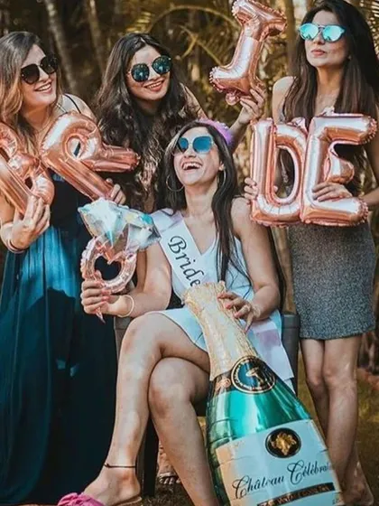 Fun with foil balloons! Having the bridesmaids hold up "BRIDE" letter balloons is a fun and popular photo op for an outdoor bachelorette party.