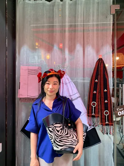 A guest posing in front of our restaurant, decorated with traditional Naga textiles for the Tuluni festival. We love it when our guests embrace our culture with us.