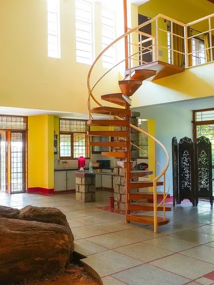 The spacious and well-lit interior of our main villa, featuring a unique blend of natural stone and modern design.