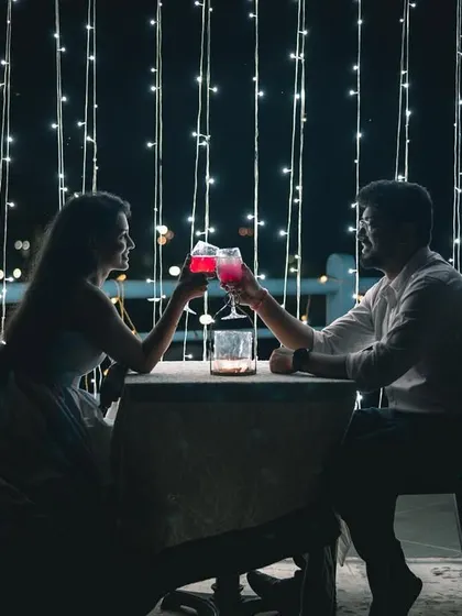 A romantic date night setup is a perfect theme for a pre-wedding shoot. Here, we used fairy lights and a cozy table setting to create an intimate, silhouetted portrait that feels straight out of a movie.