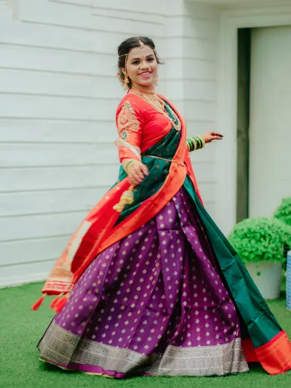 A full length shot of the bride twirling in her gorgeous purple and green lehenga saree, a picture of grace and happiness.