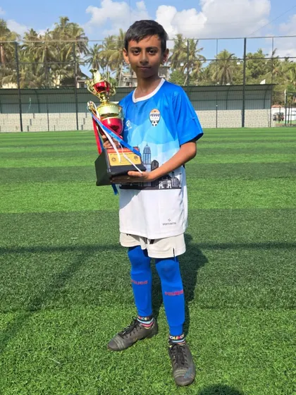 A young player from our U12 squad posing with his winner's trophy.