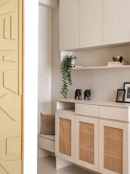 Exploring the nooks and corners that make a design special. This foyer unit combines a seating bench with a wicker-front shoe cabinet and open shelving for decor.