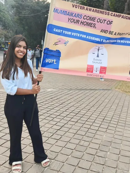 A young volunteer proudly holds the Rann Samar banner during our voter awareness campaign. Engaging the youth and first-time voters is critical for building a culture of active democratic participation.