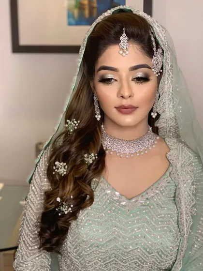 A close-up of Farheen's Walima makeup. The silver glitter on the lids adds a touch of sparkle, while the matte skin provides a perfect canvas.