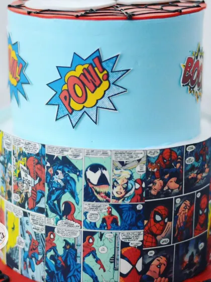 The edible comic strip wrap is a great way to add action and detail to a superhero cake.