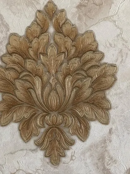 A close-up of the embossed texture and intricate detail of the gold damask motif.