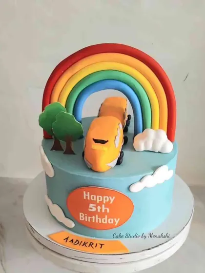 For a child who loves trains. This cake features a yellow train coming through a bright rainbow tunnel, creating a cheerful and colorful scene.