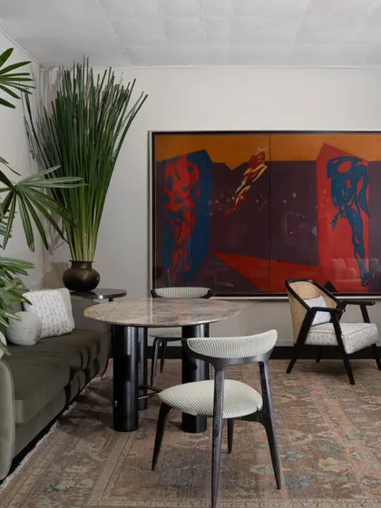Another view of the India Art Fair VIP Lounge, where a large, colourful painting provides a dramatic backdrop for a dining or meeting area. The space was designed to reflect the depth and evolving language of contemporary Indian design.