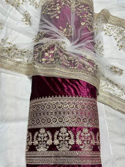I've paired this rich maroon viscose velvet with a delicate embroidered net fabric. This combination is perfect for creating opulent lehengas or salwar suits that feel both royal and handcrafted.