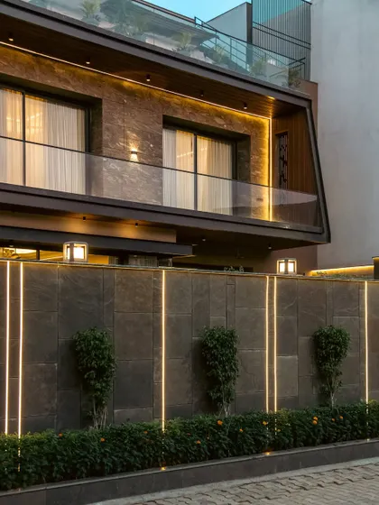 At the Club Drive House, we integrated linear LED strips into the boundary wall. This not only illuminates the perimeter but also creates a strong graphic statement, turning a functional element into a piece of art that complements the home's modern facade.