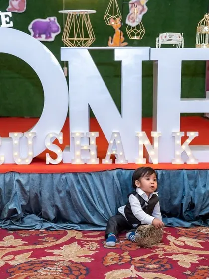 A candid moment of the birthday boy exploring his amazing jungle-themed party setup before the guests arrive.