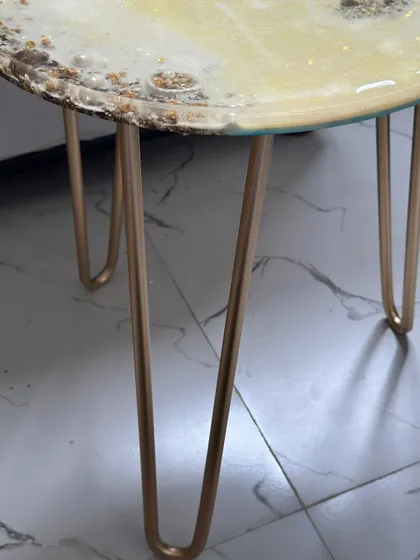 The finished beach-themed table with its elegant gold hairpin legs. This piece is a perfect fusion of a personal memory and high-end home decor.
