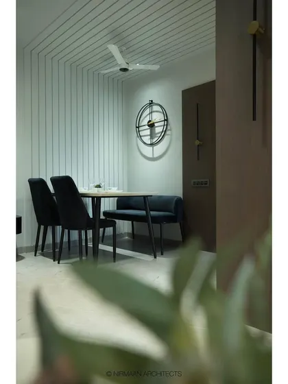 A cozy dining nook at our Tulsi Heights project. We used linear patterns on the wall and a comfortable bench seating to create an intimate and stylish space that feels distinct yet connected to the living area.