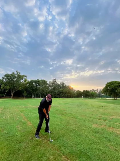 A golfer practices his chipping into the sunset. Those golden hour sessions are something special.