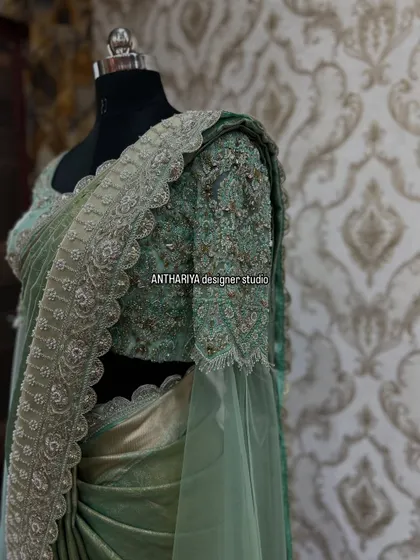 A close-up of the intricate silver embroidery on the blouse and the delicate net sleeves.