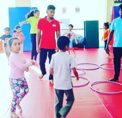 Our "Giggle Worms" enjoying a warm-up activity with hula hoops, learning about numbers and counting while they move.
