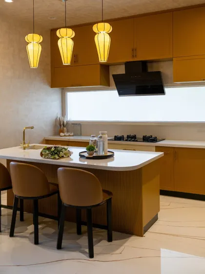 The fluted detail on the island base adds texture and sophistication to this modern, open-plan kitchen.