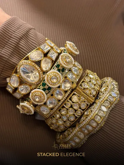 Bangles that blend craft and charm. A close-up of a luxurious stack of polki bangles, showcasing different widths and designs.