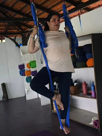 Every student's journey is unique. Here, a participant in our retreat takes her first steps into aerial yoga, finding her balance and confidence in the hammock.