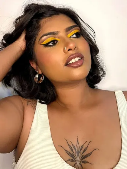 A duplicate image for context. A bold and graphic look featuring a vibrant yellow eyeshadow.