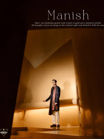 A dramatic and stylish portrait of the groom in a modern, architectural space. The lighting and composition create a powerful, high-fashion look.
