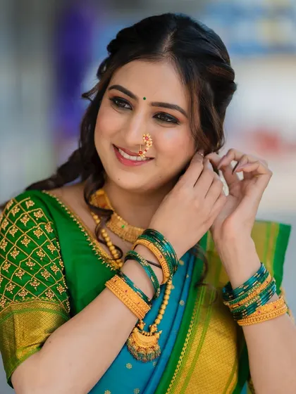 Keeping it fresh and flawless with this dreamy engagement look. The makeup is soft and radiant, complementing her beautiful blue and green saree.