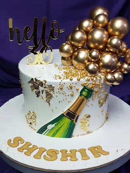 Say "hello 30" with a pop of champagne. This elegant cake features a hand-painted champagne bottle with golden bubbles and edible gold leaf, creating a sophisticated and celebratory design for a milestone birthday.