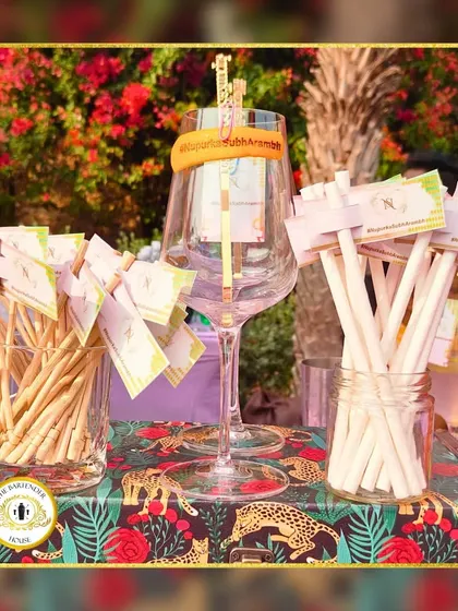 Celebrating love with personalized details. These custom drink tags and stirrers, set against a vibrant jungle-themed tablecloth, show how we match every detail to your decor.
