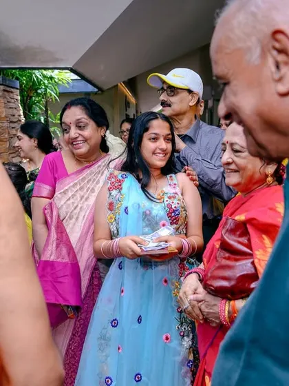 The smiles and interactions between guests are just as important as the main ceremony. This photo captures the warm atmosphere of the family gathering.