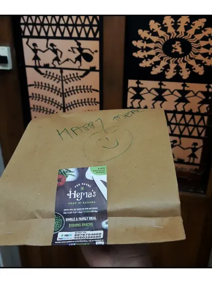 A happy meal, packed in a two layered bag with a smile, ready to be delivered.