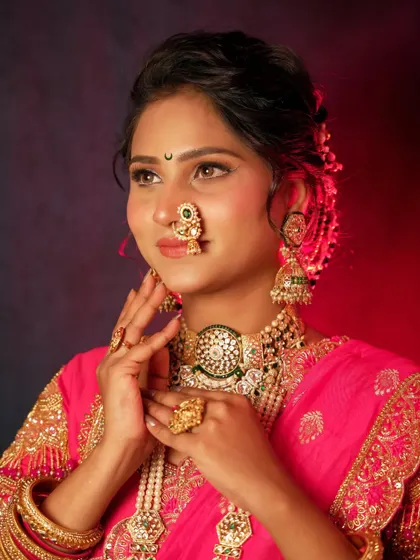 A classic bridal portrait showcasing the bride's elegant pose and stunning jewelry. The dual-tone lighting adds a dramatic and artistic touch to the photograph.