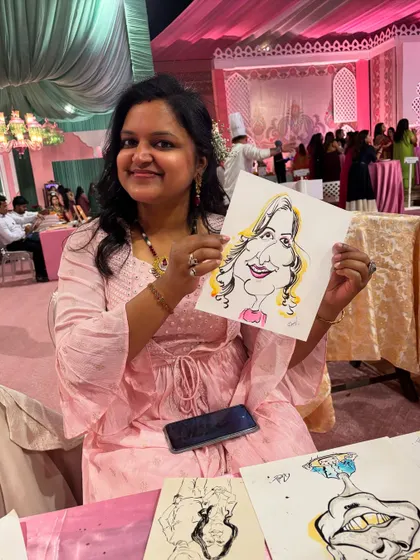 A happy guest poses with her caricature at my booth during a wedding party.