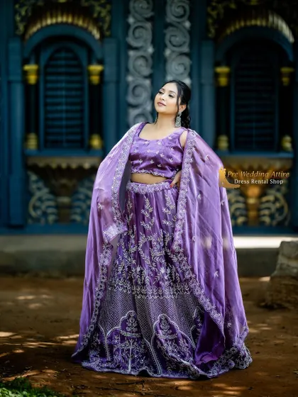 This unique purple lehenga comes with a stylish cape-style dupatta. The silver embroidery on the rich purple fabric creates a modern yet regal look.