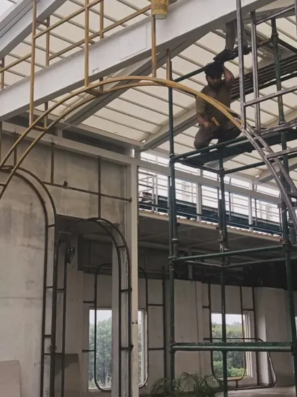 Workers installing the metal framework for the arches at the Nido project. These arches became a signature architectural element, blending modern materials with classic aesthetics.