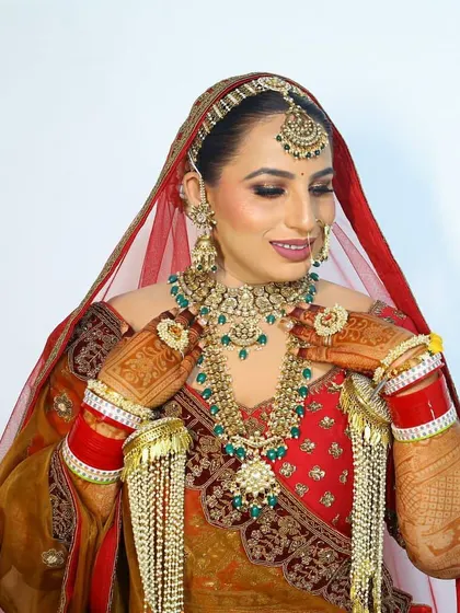Our ravishing bride Bharti in a multi-toned lehenga, wearing a complete bridal set from us, including chooda and kaleeras.
