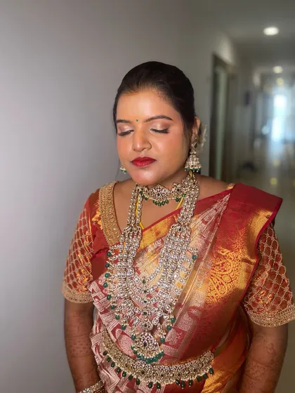 A close-up of the reception makeup. The soft shimmer on the eyes and the bold red lip create a classic glam look that is perfect for any evening event.