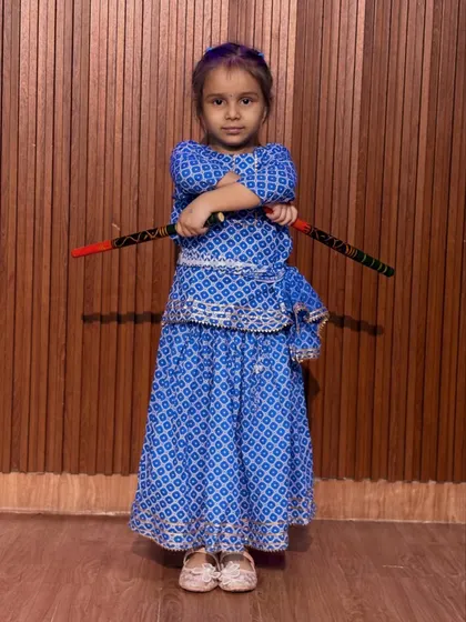 A confident pose from a young dancer in her blue bandhani outfit. Our classes help build stage presence and self-assurance in a fun, encouraging setting.