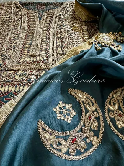 A close-up on the embroidered crescent moon motifs of the dupatta, which are meticulously crafted with Gota Patti work, echoing the details on the kurta.