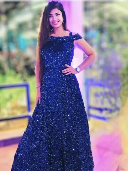 This royal blue sequin gown is perfect for a cocktail party or reception. The off-shoulder design and all-over sparkle make it a glamorous and eye-catching choice.