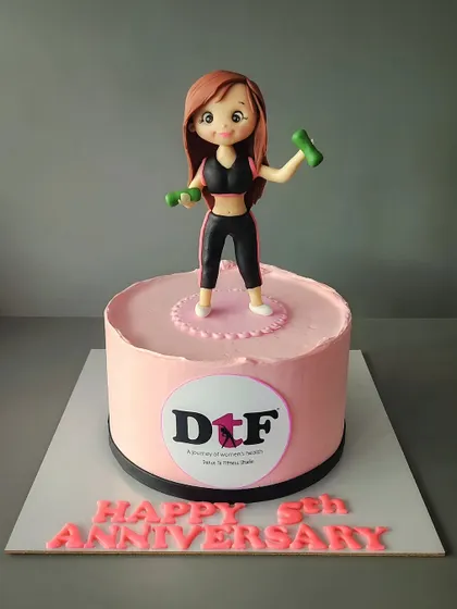 A minimalist cake for the 5th anniversary of Dance to Fitness. The topper is handmade and edible, celebrating fit and strong women.