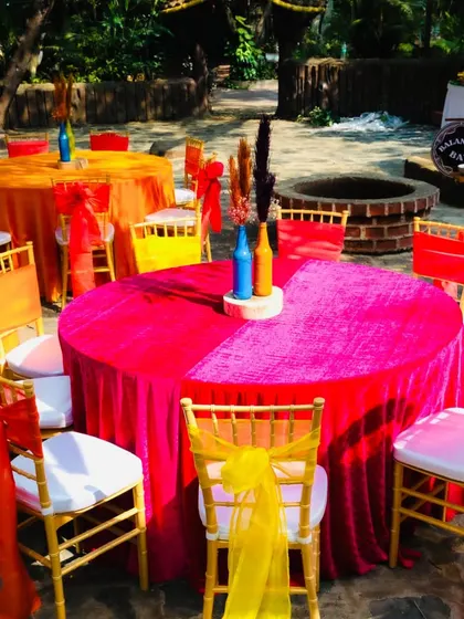 The guest tables were covered in bright pink and orange velvet cloths, with simple, colorful centerpieces, adding to the fun and festive carnival vibe.