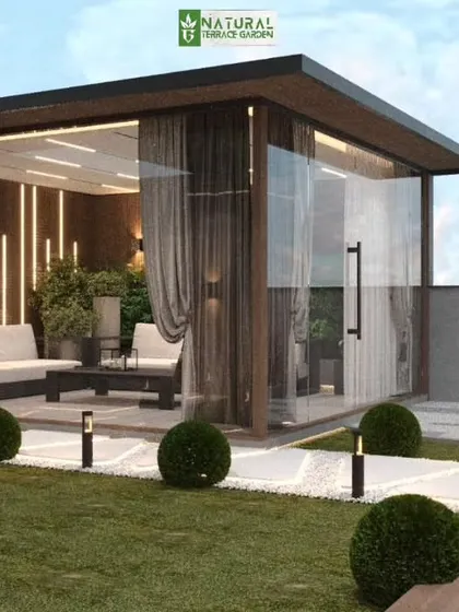 A close-up of the proposed glass house in the Vikaspuri design. The room is elegantly furnished and features curtains for privacy, making it a true outdoor sanctuary.