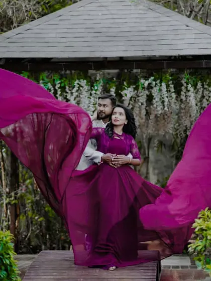 The "flying" effect of the purple gown, creating a wing-like shape around the couple. This is a signature shot that I love to help create.