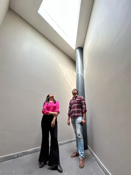 The co-founders looking up at a dramatic skylight in one of our projects. We love documenting our work and these on-site moments are special to us.
